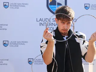 Rubén Silva performing with rings during a school magic show